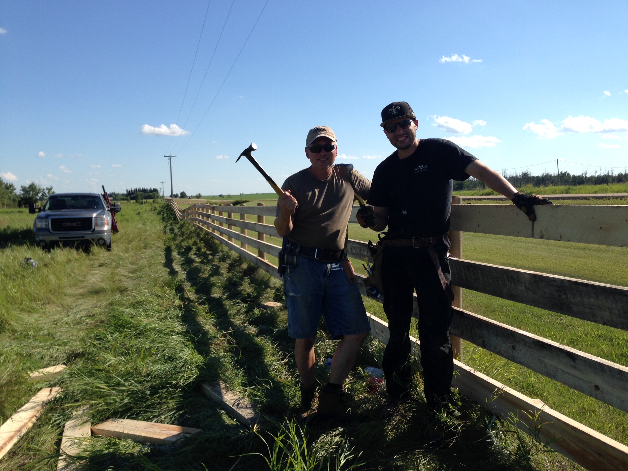 Alberta Wild West Fencing team building a 4 plank lumber fence
